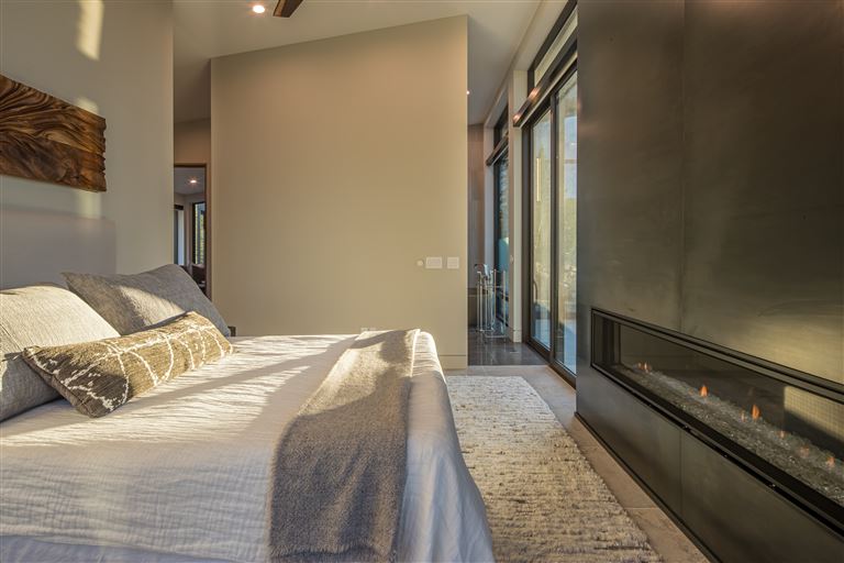 Contemporary luxury hotel bedroom with modern furniture and minimalist decor.