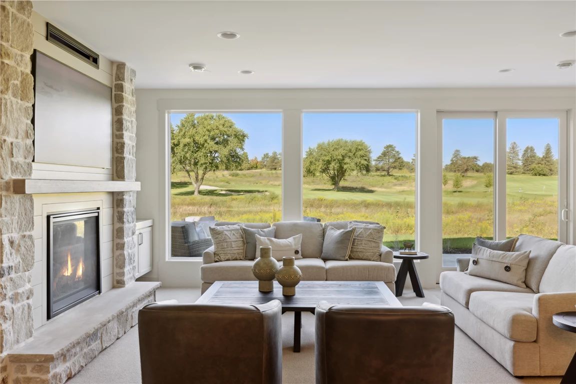 Contemporary family room with minimalist design, featuring a sofa, coffee table, and fireplace.