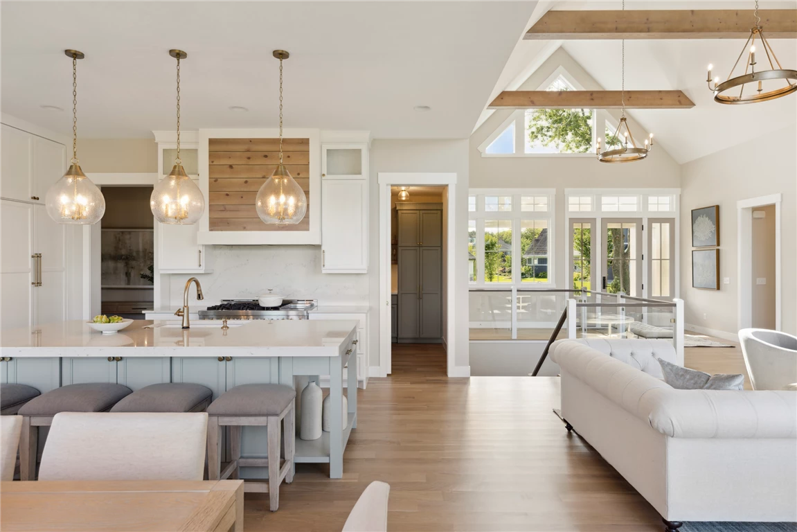 Contemporary kitchen and living room with modern furniture and large windows.