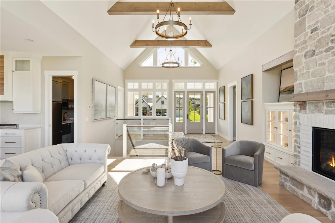 Contemporary luxury living room with sofa, coffee table, and large windows.