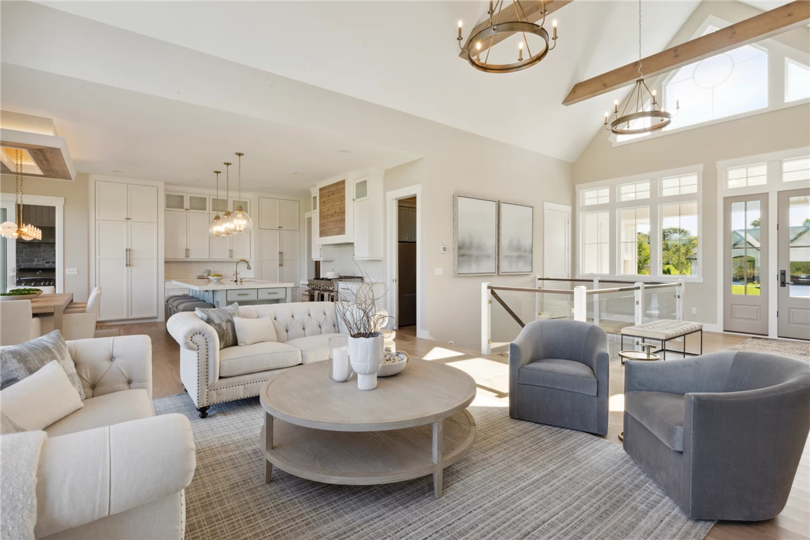 Luxury contemporary living room with a sofa, coffee table, and large windows.