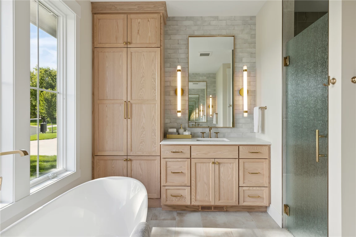 Luxurious contemporary master bathroom with bathtub and modern fixtures.