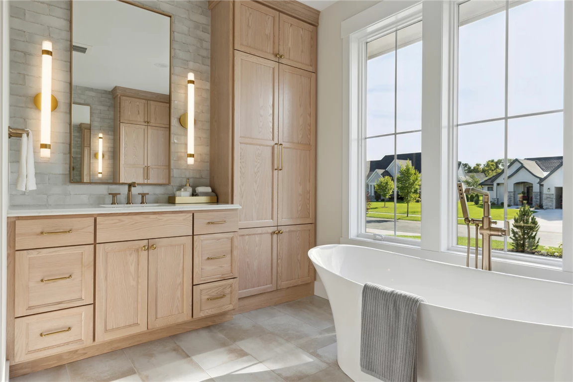 Luxurious contemporary master bathroom with minimalist design and large windows.