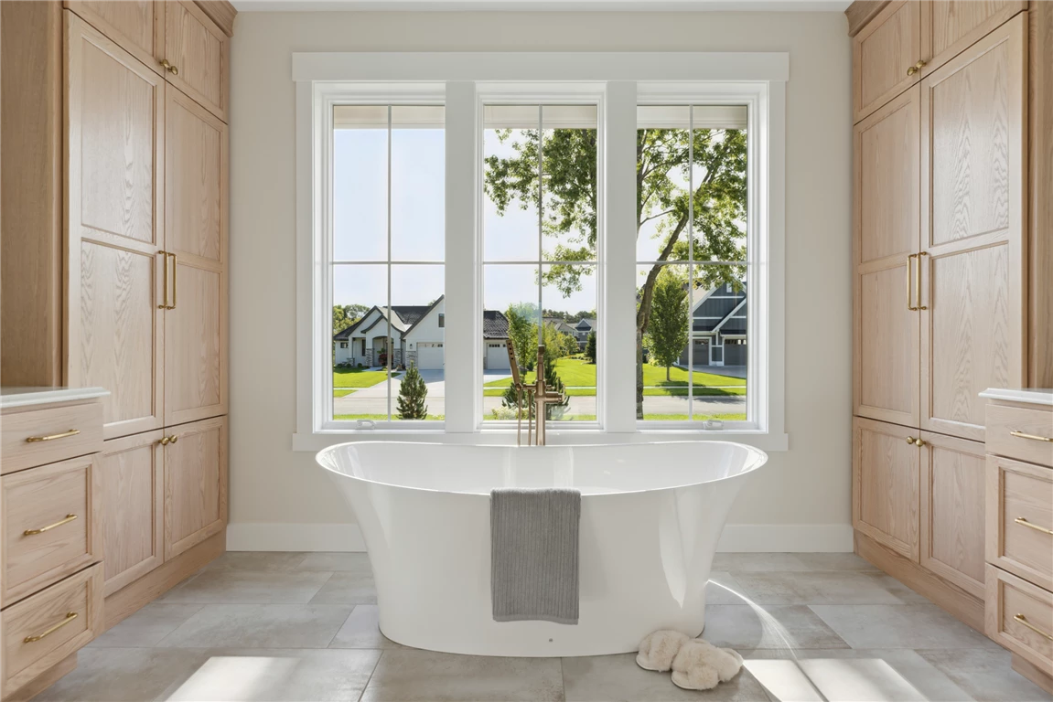 Contemporary luxury master bathroom with a bathtub and modern design.