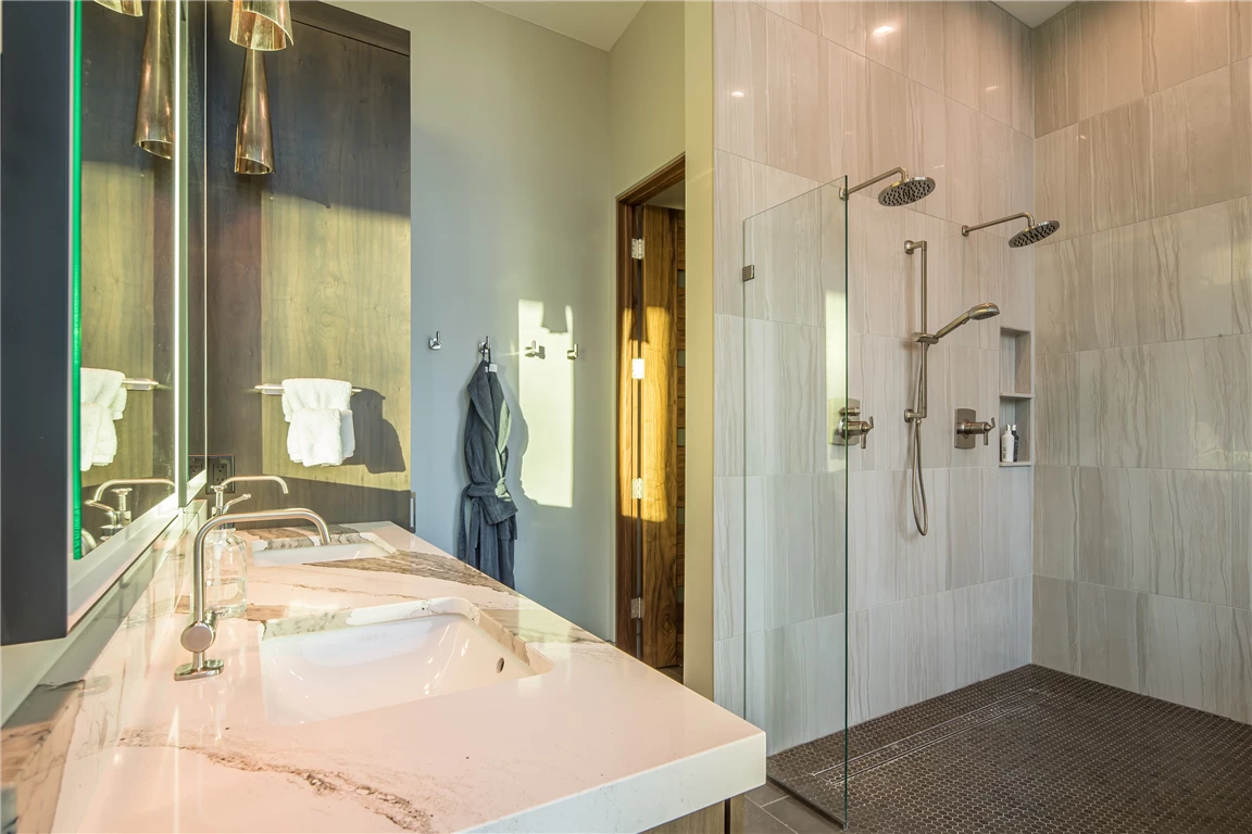 Contemporary luxury bathroom with a mirror, bathtub, and modern fixtures.