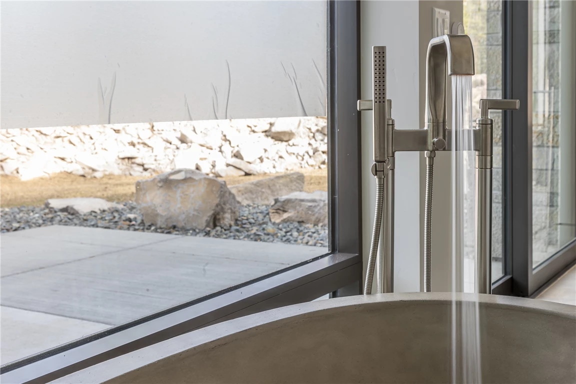 Winter beach house with large windows and snowy landscape