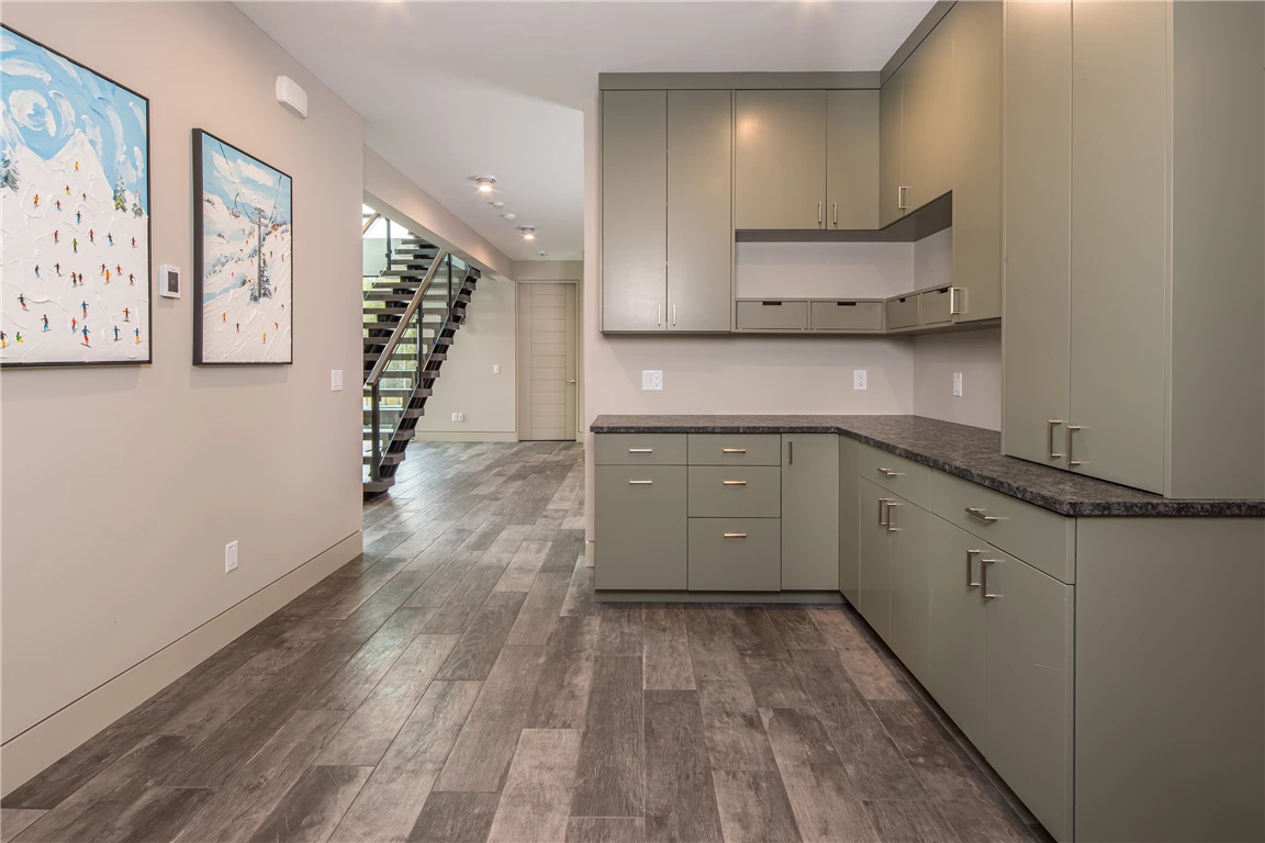 Contemporary butler's pantry with modern appliances and minimalist design.