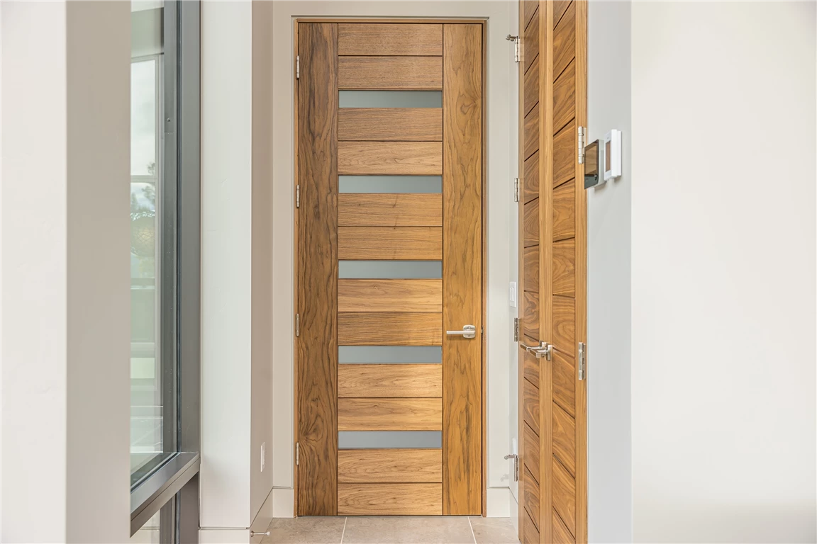 Contemporary wooden door in a classic interior design setting.