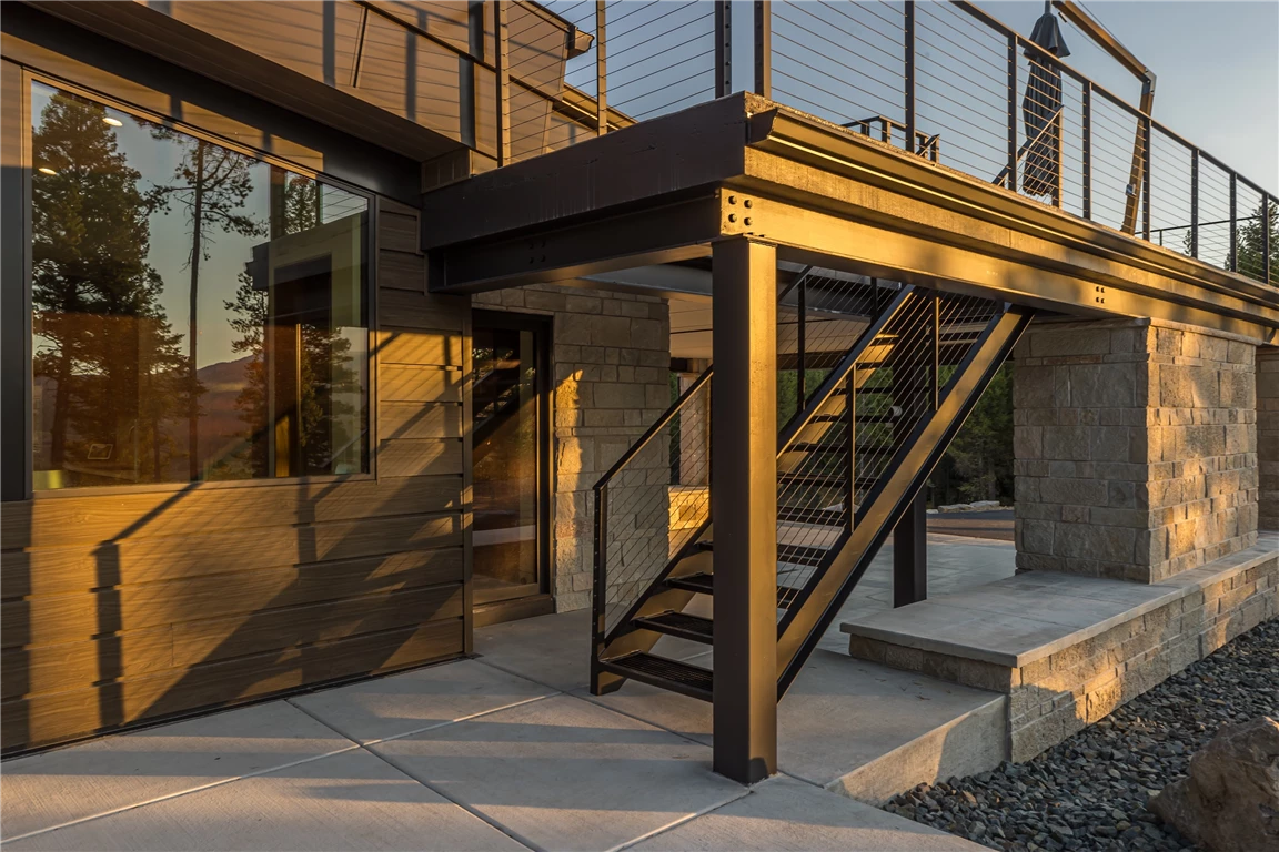 Modern outdoor stairs in an urban architectural setting with glass and wood elements.