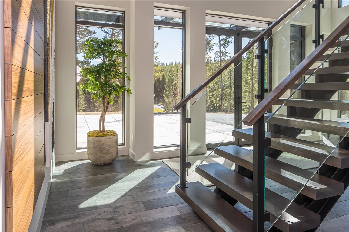 Contemporary luxury staircase with wooden and glass elements in a modern home.