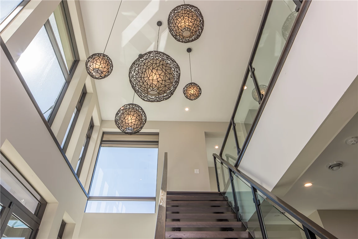 Modern indoor staircase with glass and mirror design in an urban setting.