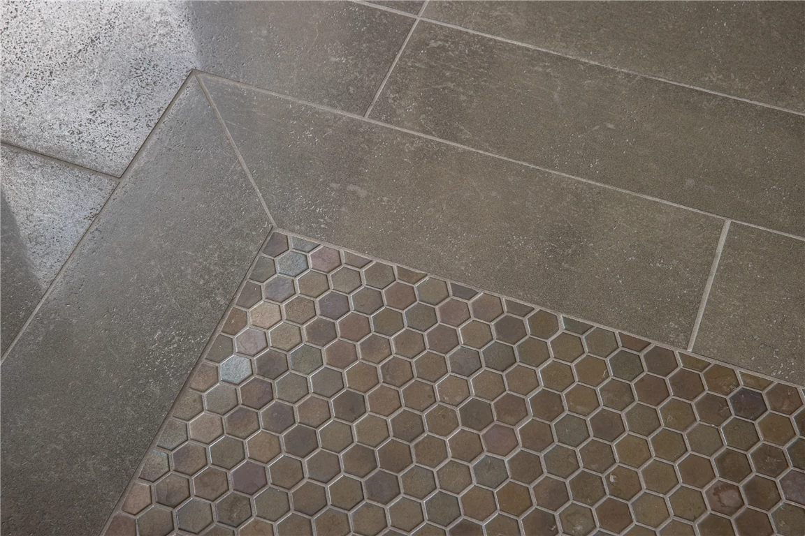 Closeup of gray mosaic tile design with intricate pattern.